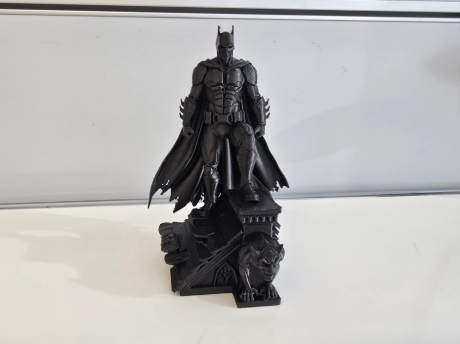 Batman on rooftop pedestal